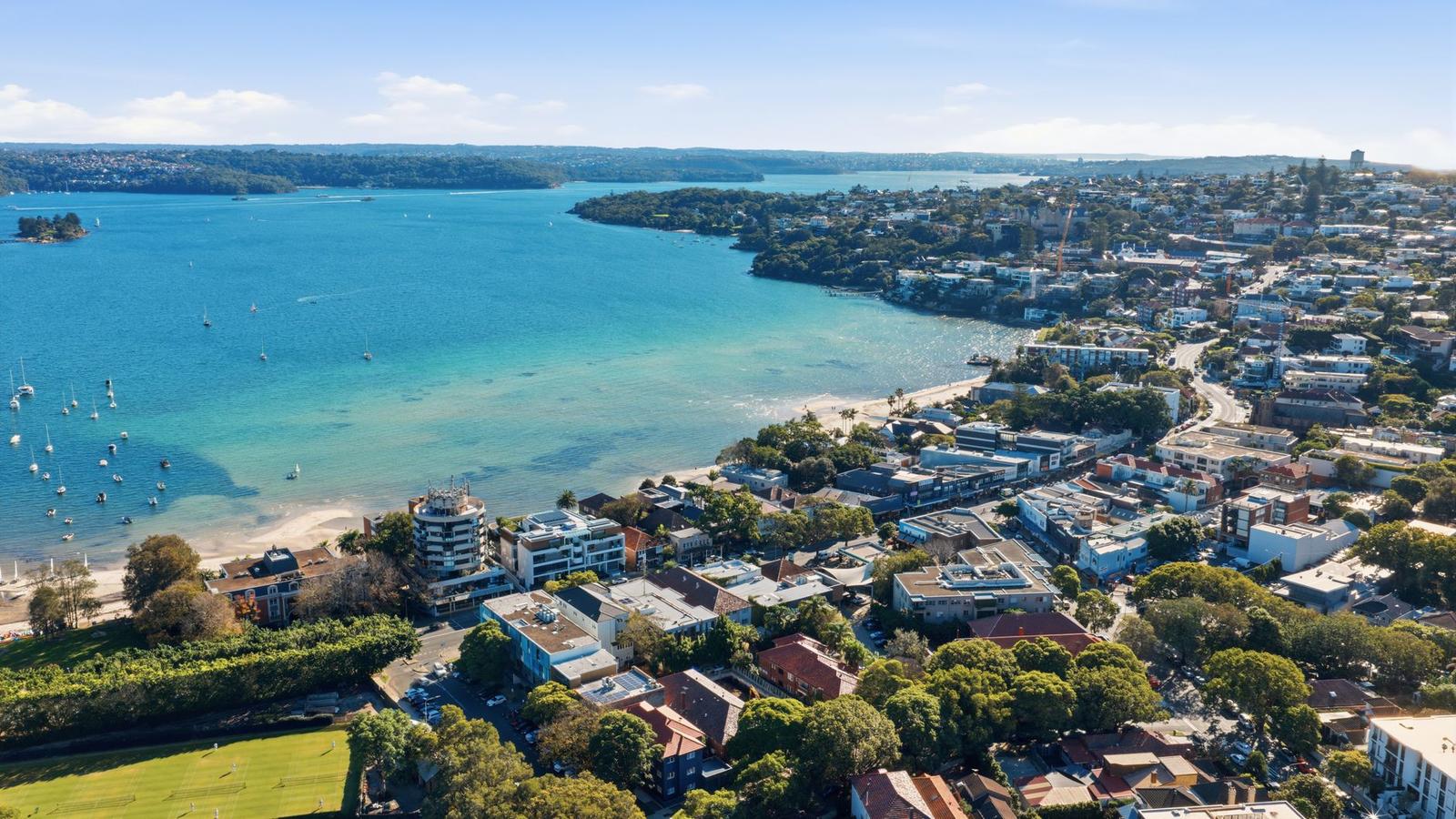 Aerial View of Coastal Suburb with Boats in Bay
